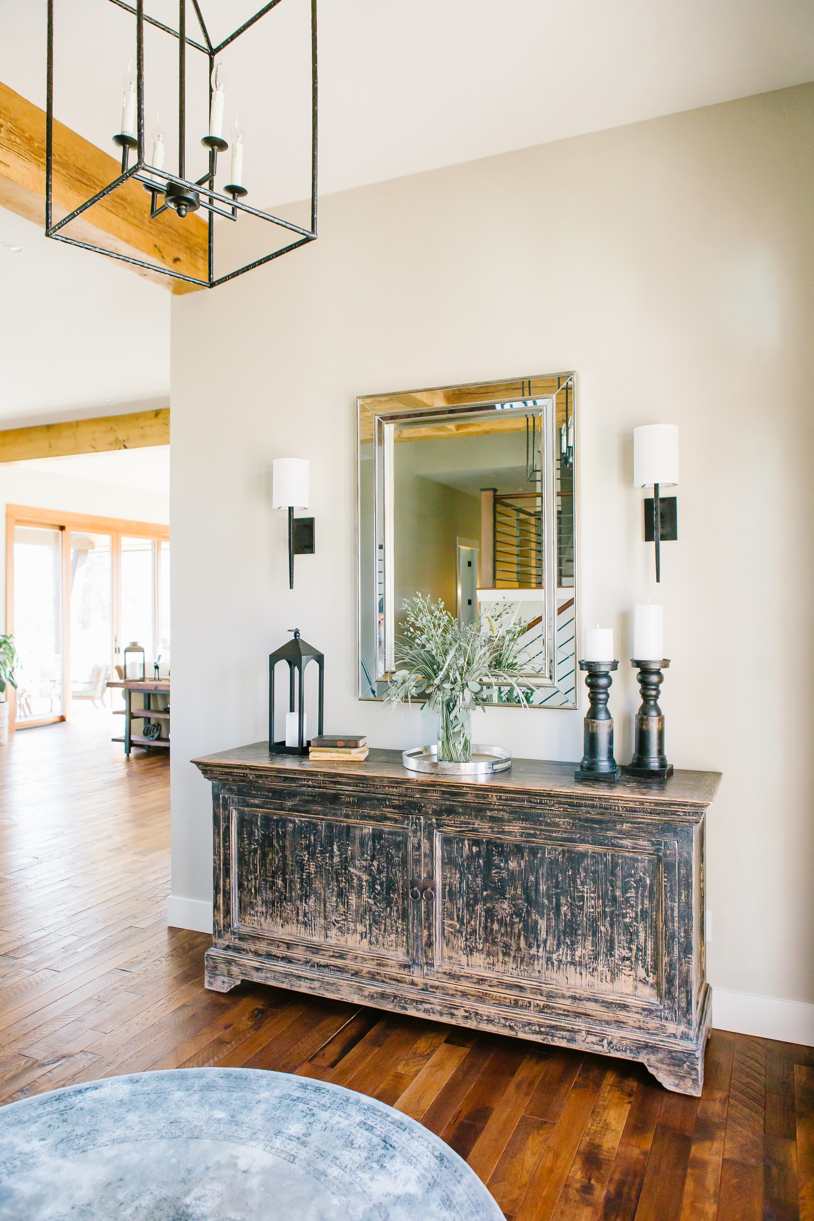 Worn wooden credenza with mirror and decor
