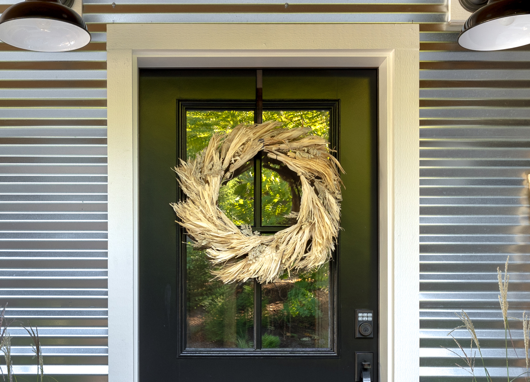 Fall wreath hanging on a black front door