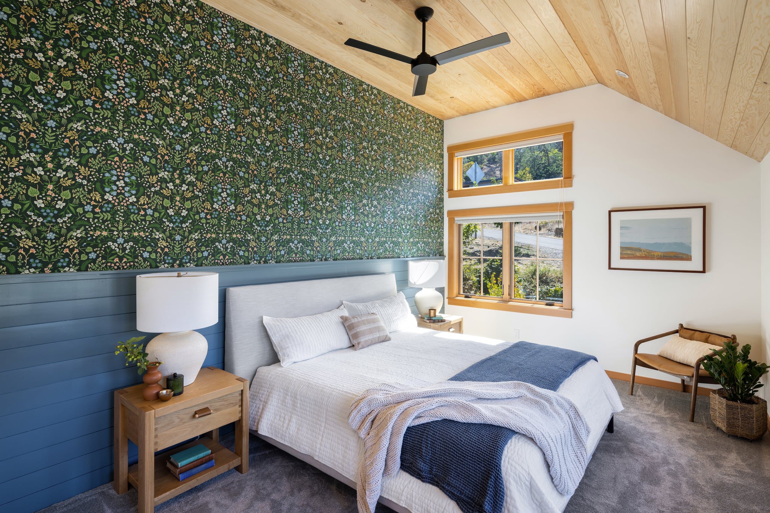 a bedroom with a wooden roof and colorful wallpaper