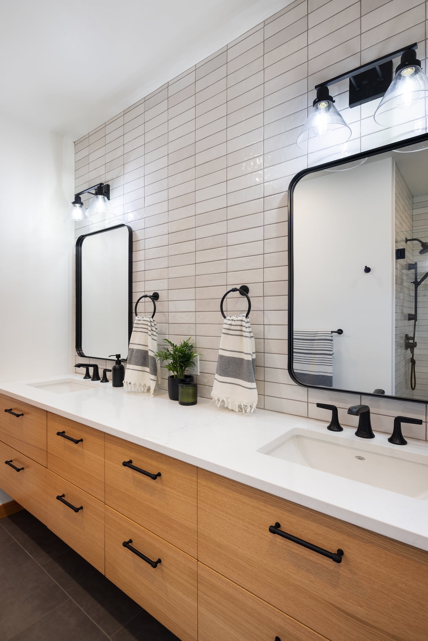 a modern two person bathroom sink setup with subway tile